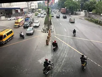 Motorcyclists ride through traffic