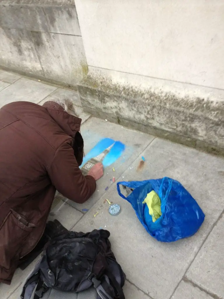 Man using chalk to draw St. Stephan’s Tower, AKA Big Ben